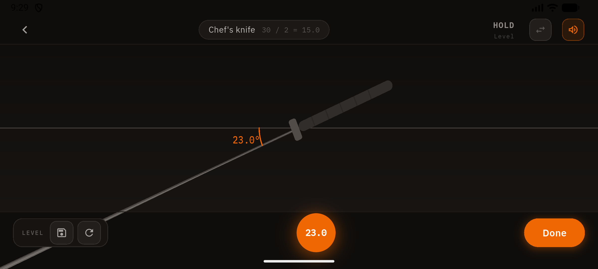 Sharpening angle meter — phone rests on the blade